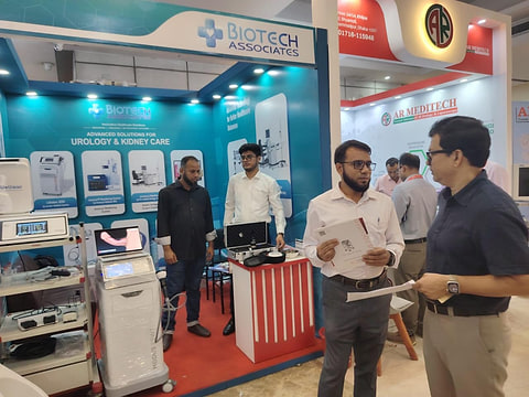 Clinicians reviewing product literature at the Biotech Associates stand